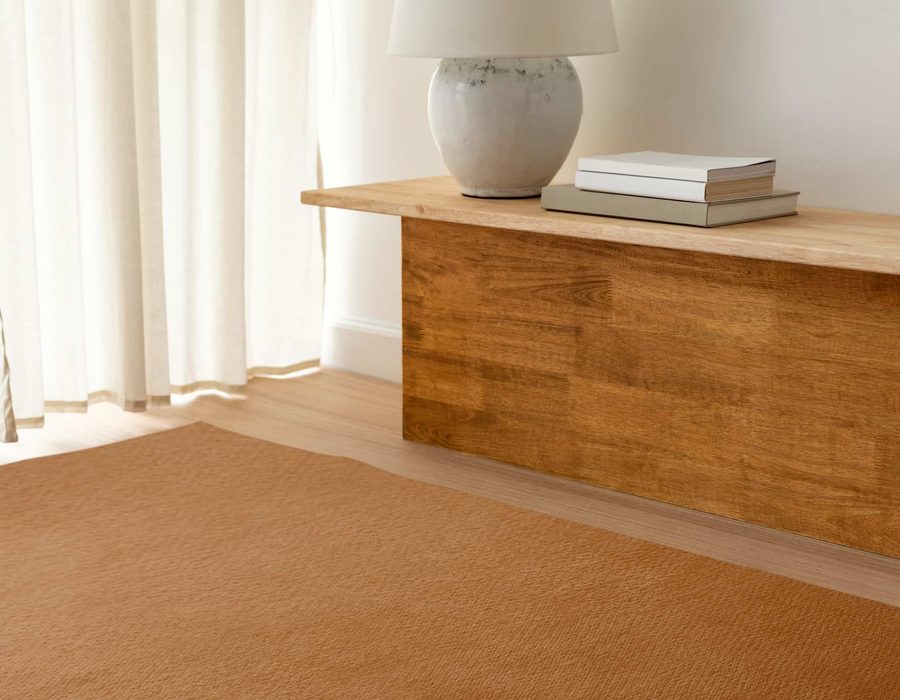 Oak and linen against a terracotta rug