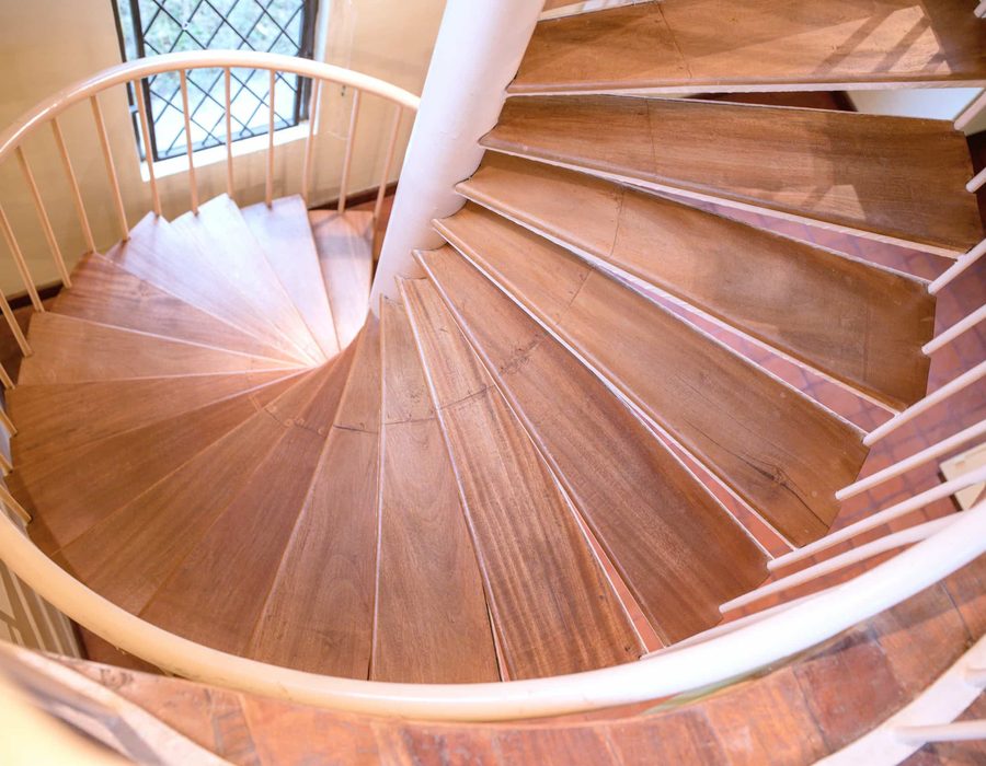 A curved timber stair in warm light
