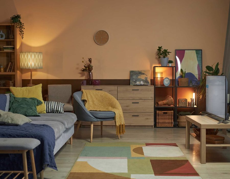 A living room lit by three lamps after dark