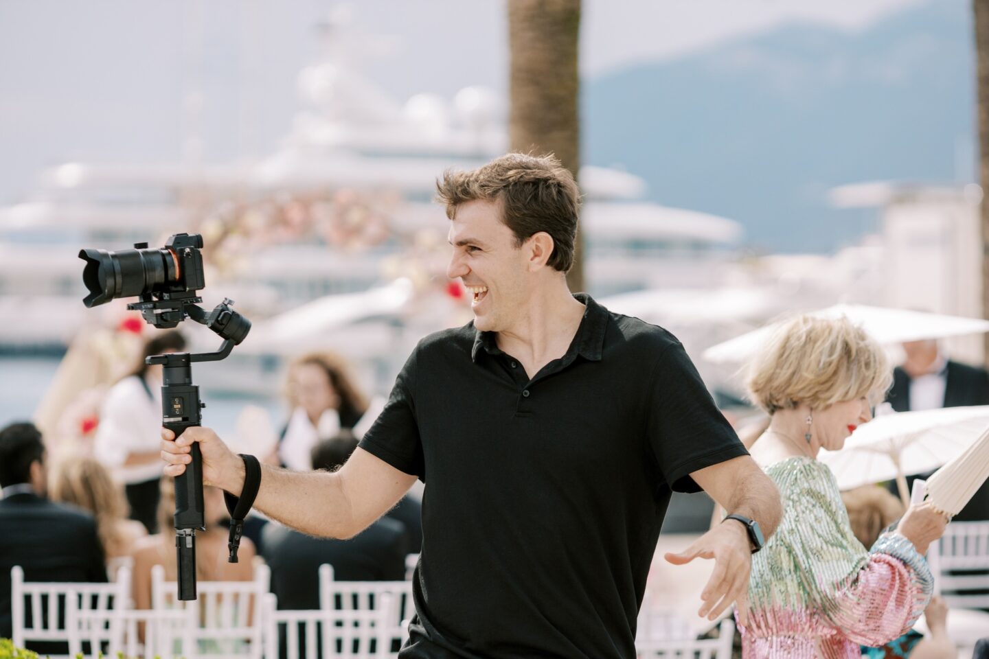 Photographer smiling while shooting a wedding ceremony