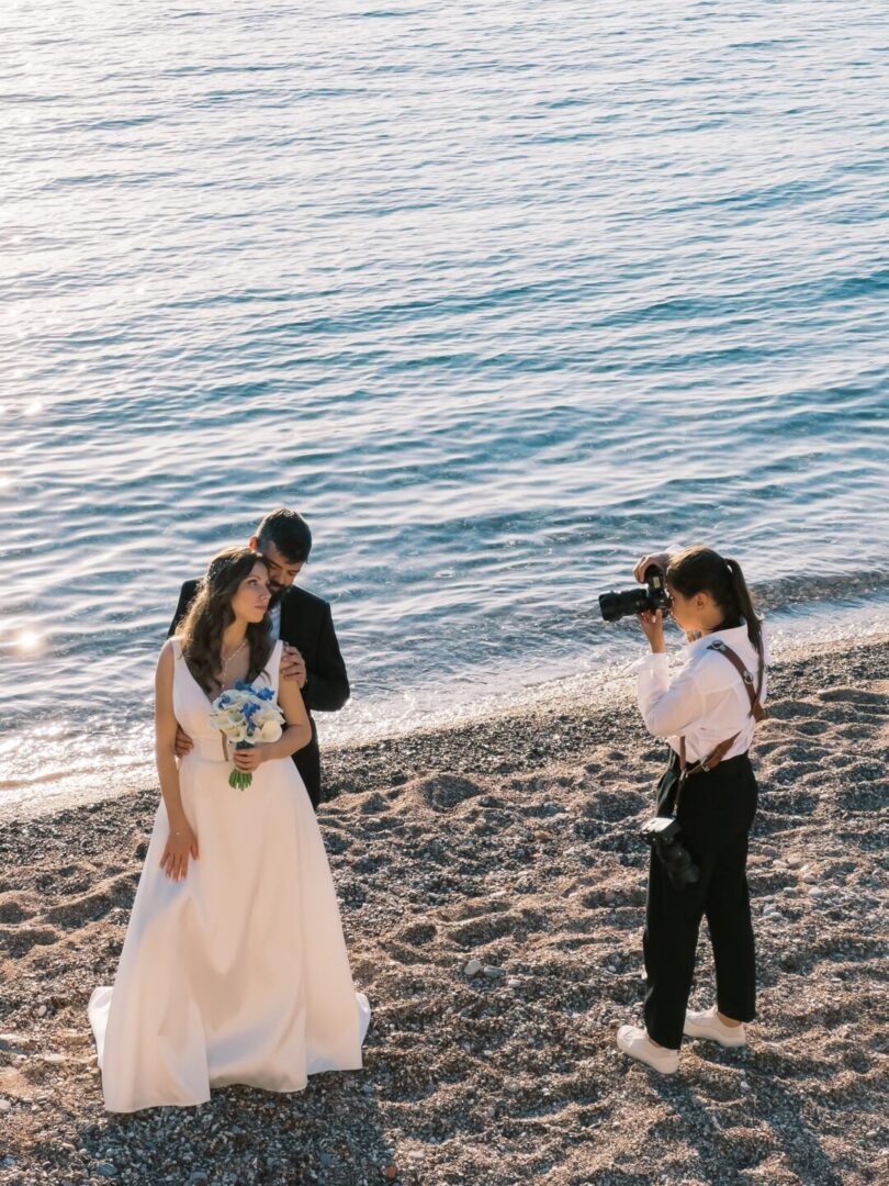 Wedding photographer capturing a couple embracing on the beach