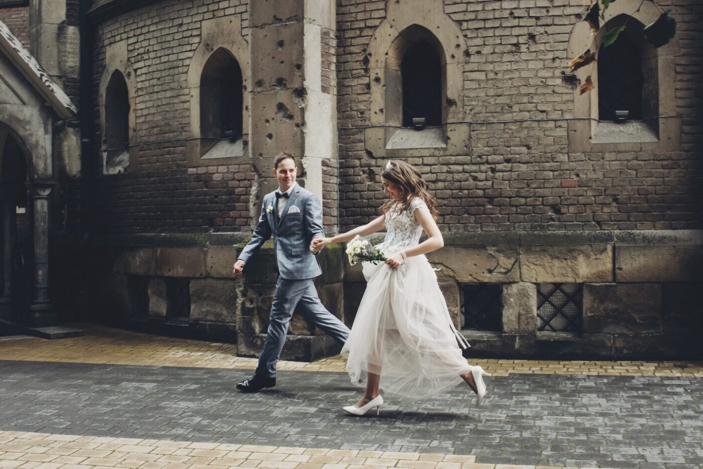 Couple running and smiling in a European city
