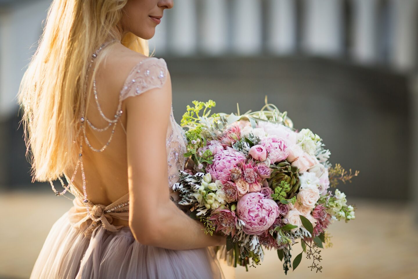 Elegant bride posing in a grey wedding dress